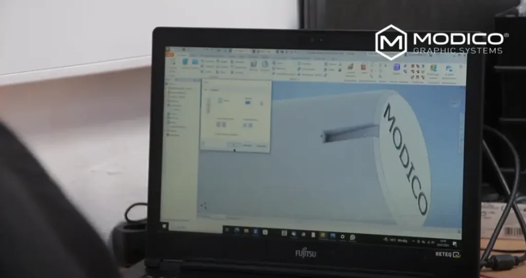 A CAD programme is running on the screen of a Modico Graphic Systems computer workstation